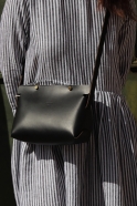 The shoulder strap triangle bag, black leather