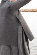 Flared sleeveless jacket, grey wool with raw edges